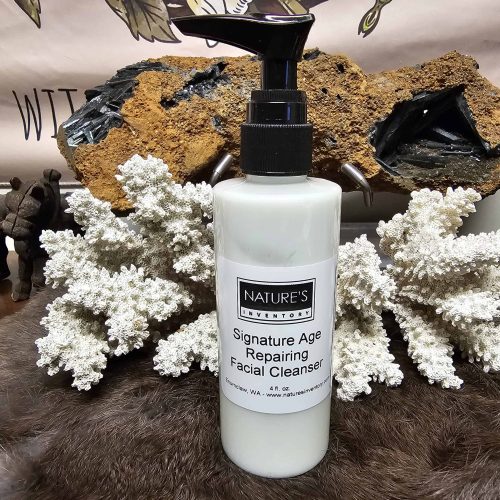 Signature Age Repairing Cleanser a white bottle with black lid