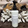 Signature Age Repairing Cleanser back of a white bottle with black lid and black cap