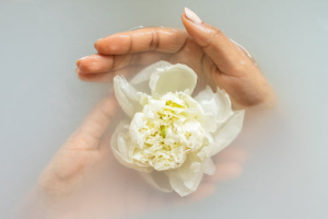 Diy Healing Baths And Soaks A Hand In Water And A White Flower In The Hand Diy Healing Baths &Amp; Soaks