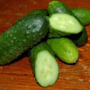 Pickling Cucumber Seeds - Bushy with sliced pickled cucumber on the table